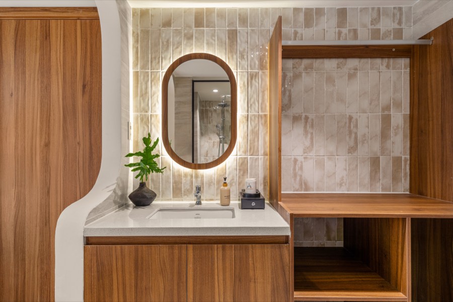 Glazed tile, a lit mirror and the hanging alcove — bathroom at Fuka House, Da Nang