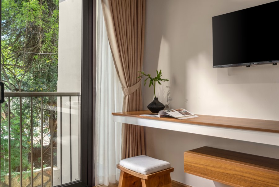 The writing desk beside the balcony door — bedroom one at Fuka House, Da Nang