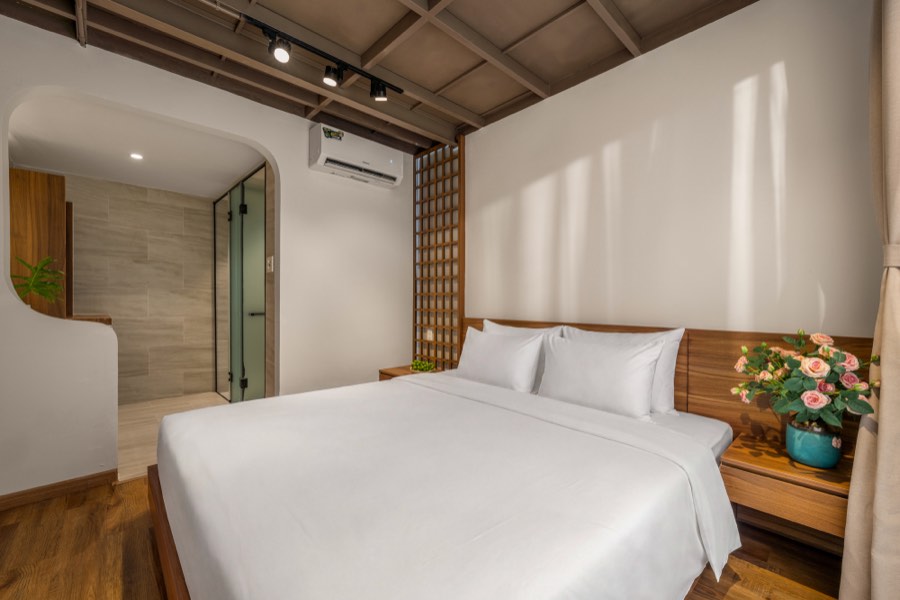 The bedroom opening straight through to its bathroom — bedroom three at Fuka House, Da Nang