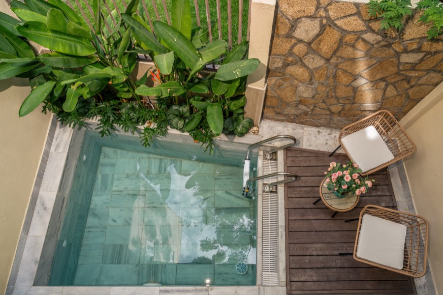 The private pool seen from above, edged with marble and banana leaves